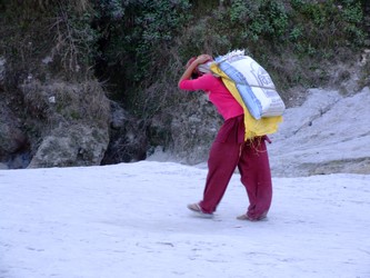 Nepalese girl carrying sand